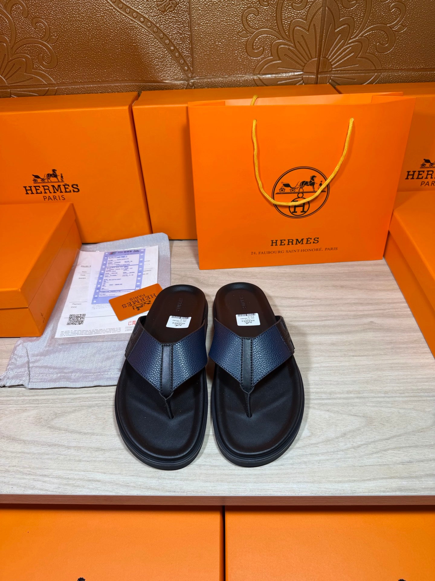 Black slide sandals with textured crossover straps and flat rubber sole