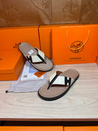 Luxury Hermes thong sandals, cream footbeds with white strap and black H buckle