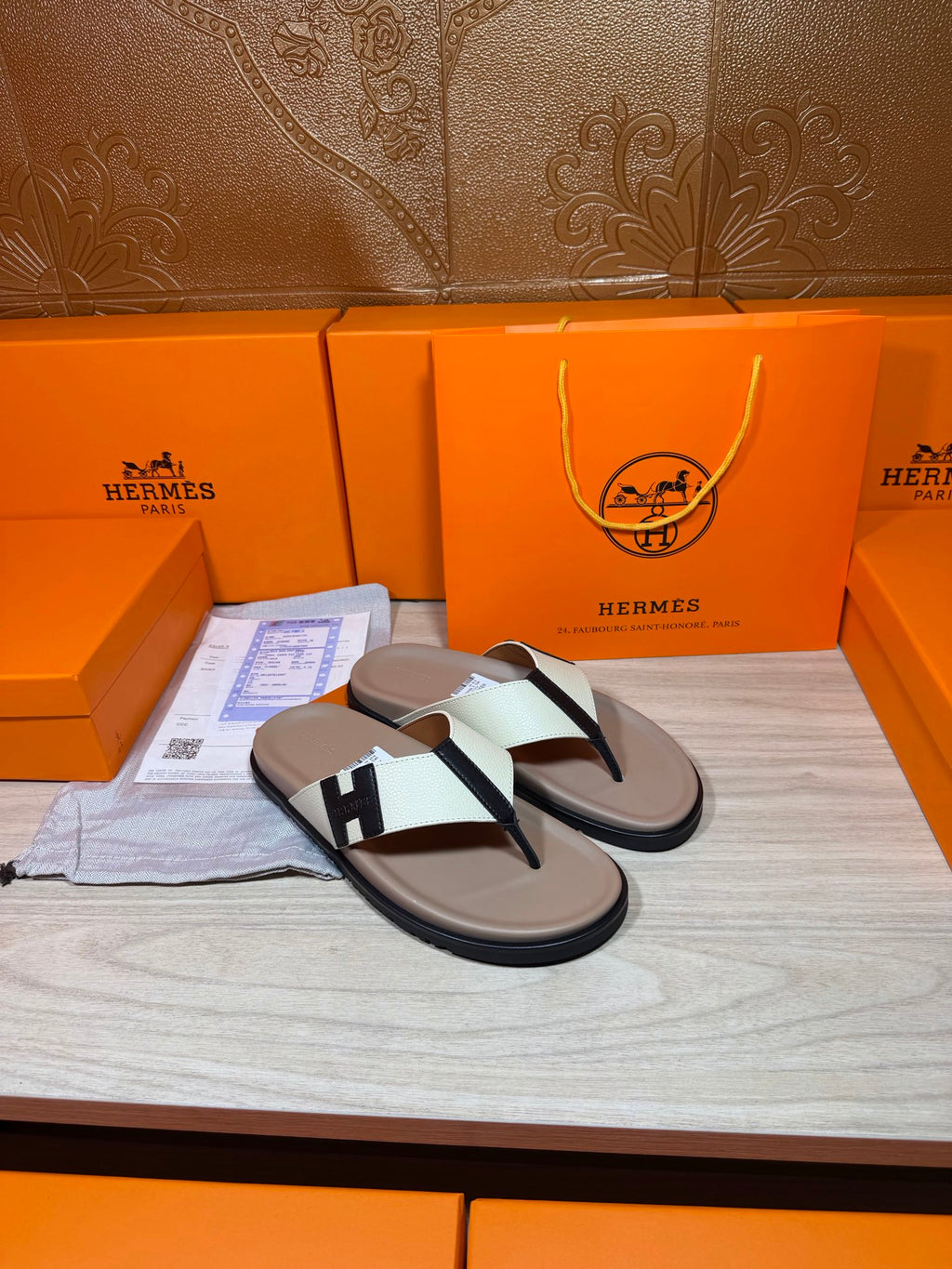Luxury Hermes flat sandals, cream footbed with white strap and black H buckle