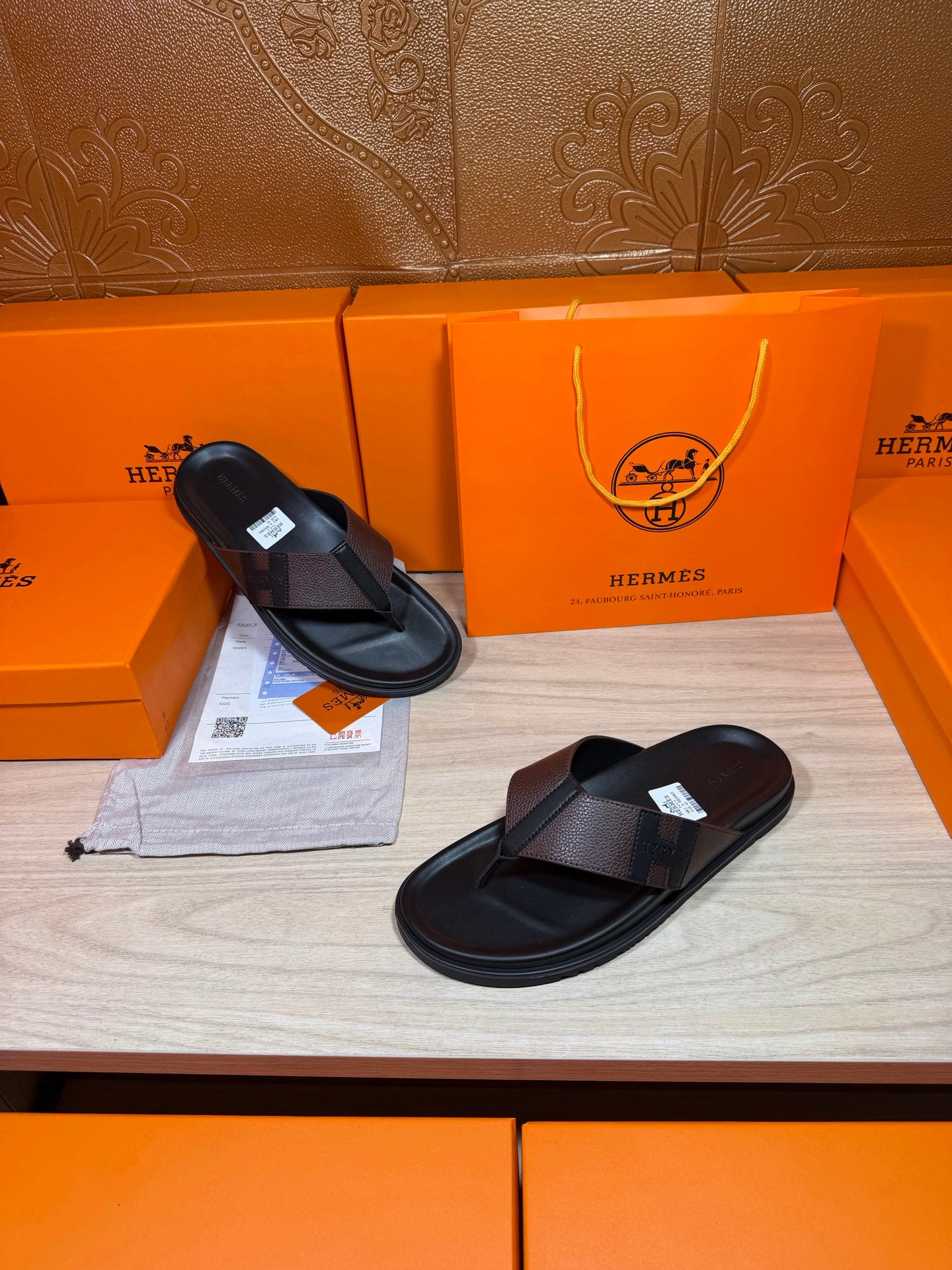 Black leather thong sandals with textured crossover straps and cushioned sole