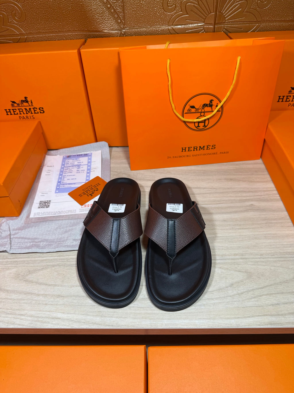 Black leather thong sandals with textured crossover strap and cushioned sole