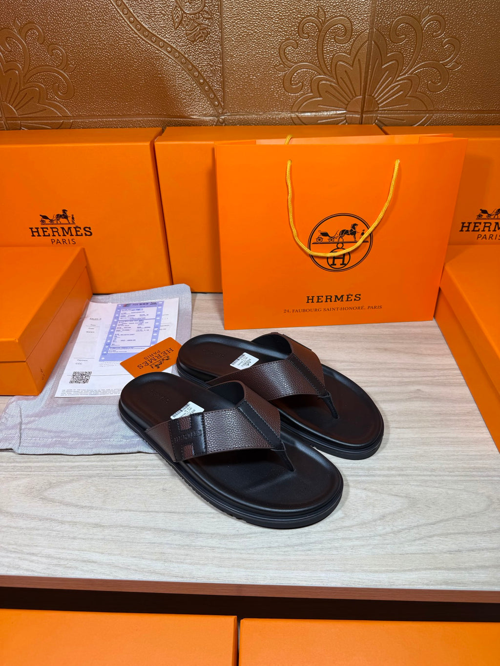 Black leather thong sandals with textured crossover strap and padded footbed