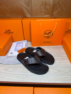 Black leather thong sandals with textured crossover strap and padded footbed