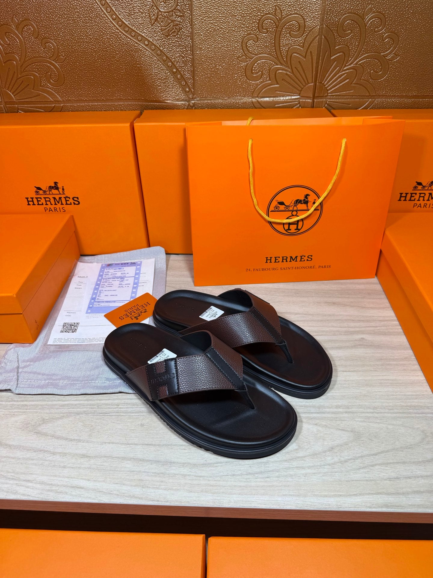 Black leather thong sandals with textured crossover strap and padded footbed