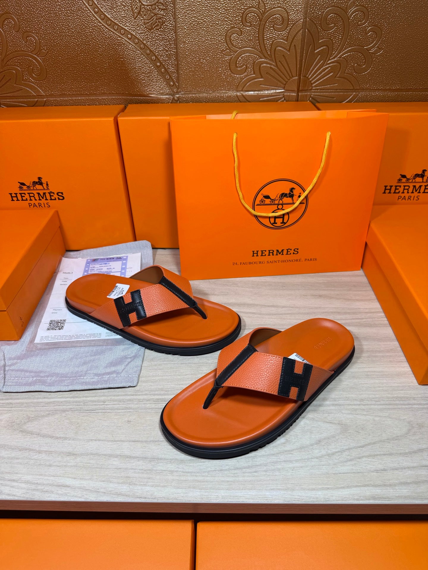 Orange Hermes thong sandals with black H strap and orange contoured footbed
