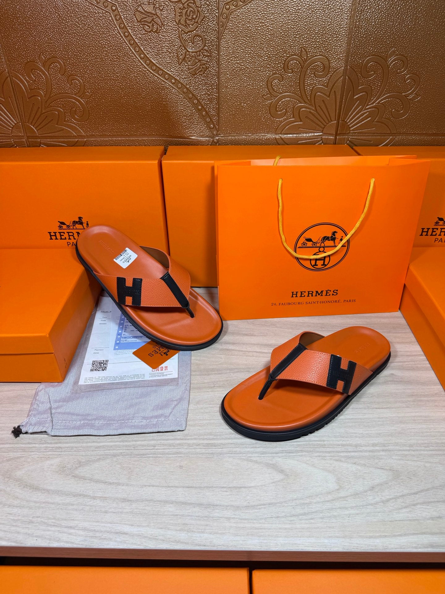 Orange Hermes thong sandals with black H strap and contoured orange footbed