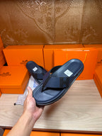 Hermes dark blue leather flip-flop sandals held up with top strap visible