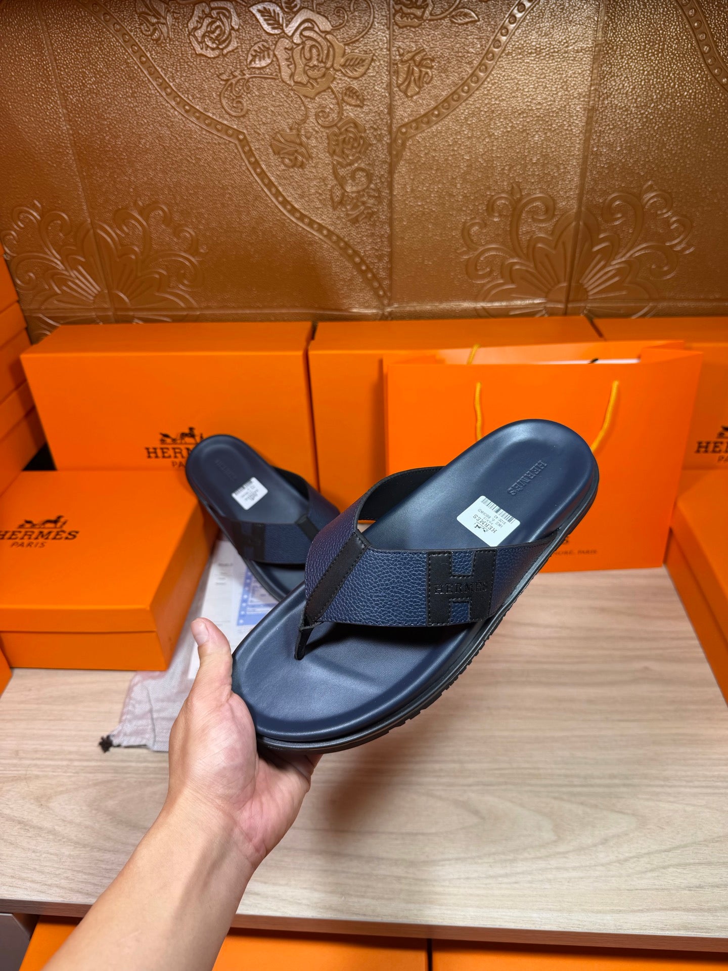 Hermes dark blue leather flip-flop sandals held up with top strap visible