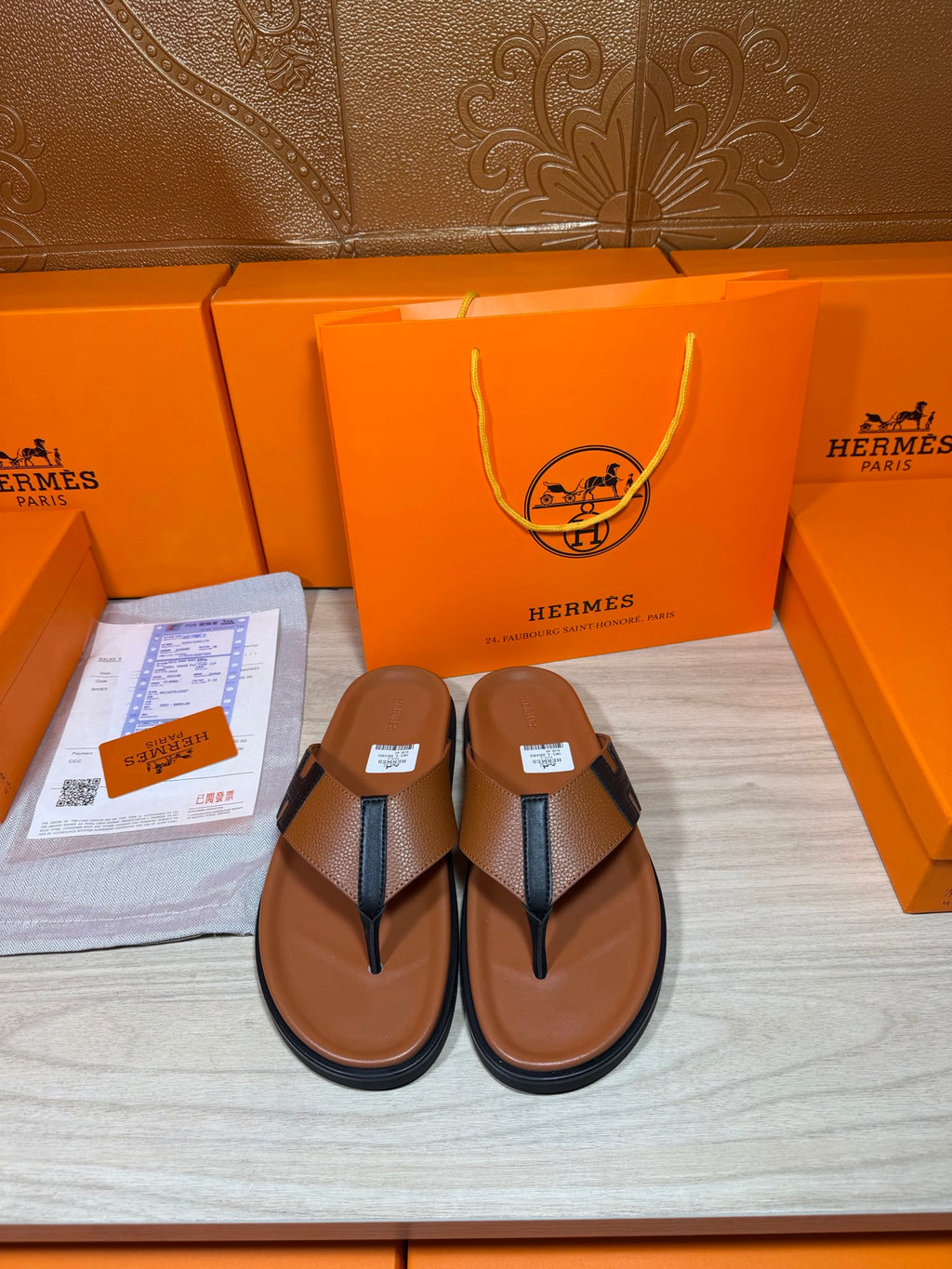 Leather thong sandals with dark H-shaped strap, brown footbeds and flat soles