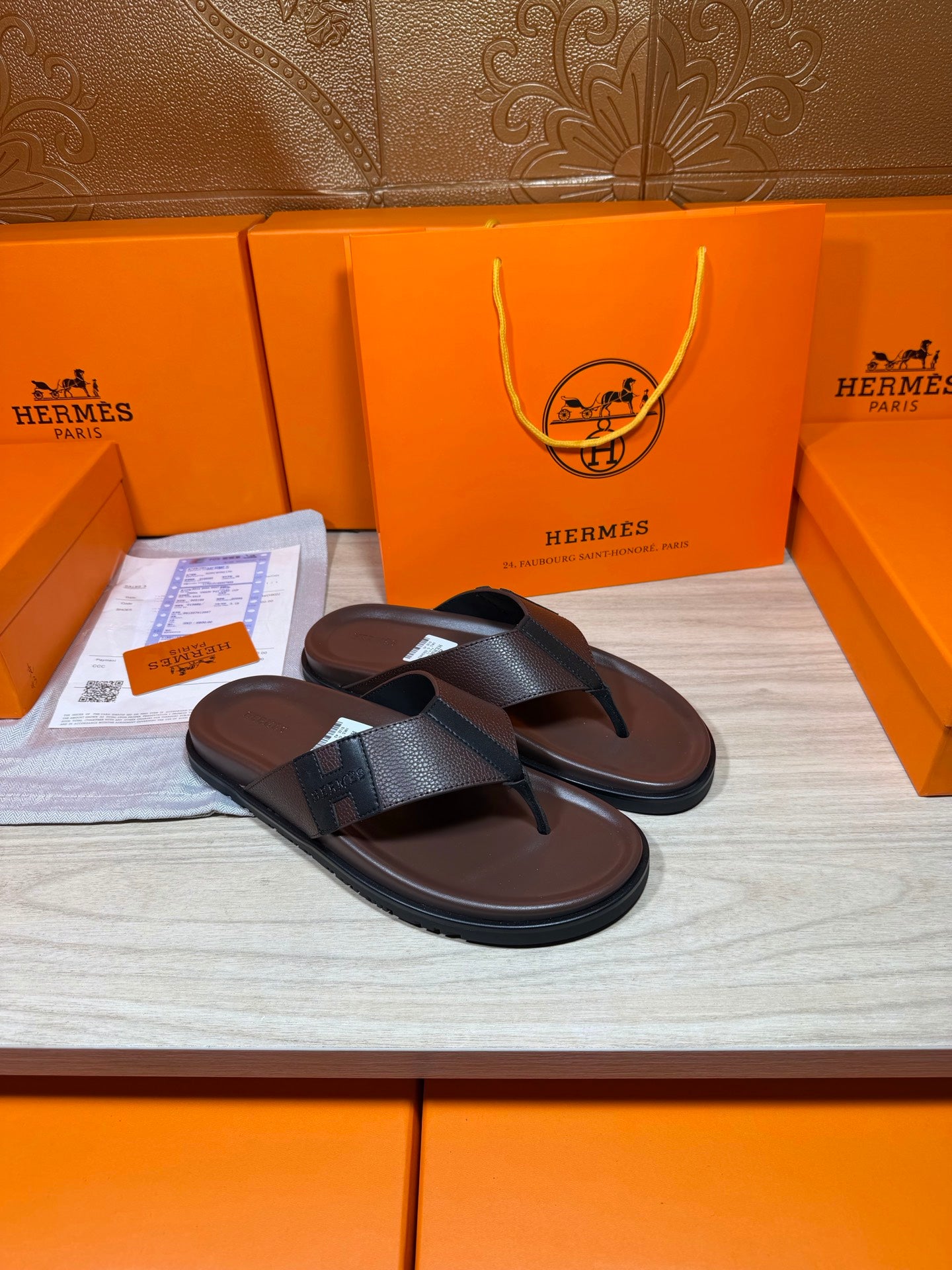 Dark leather thong sandals with black top strap and flat sole