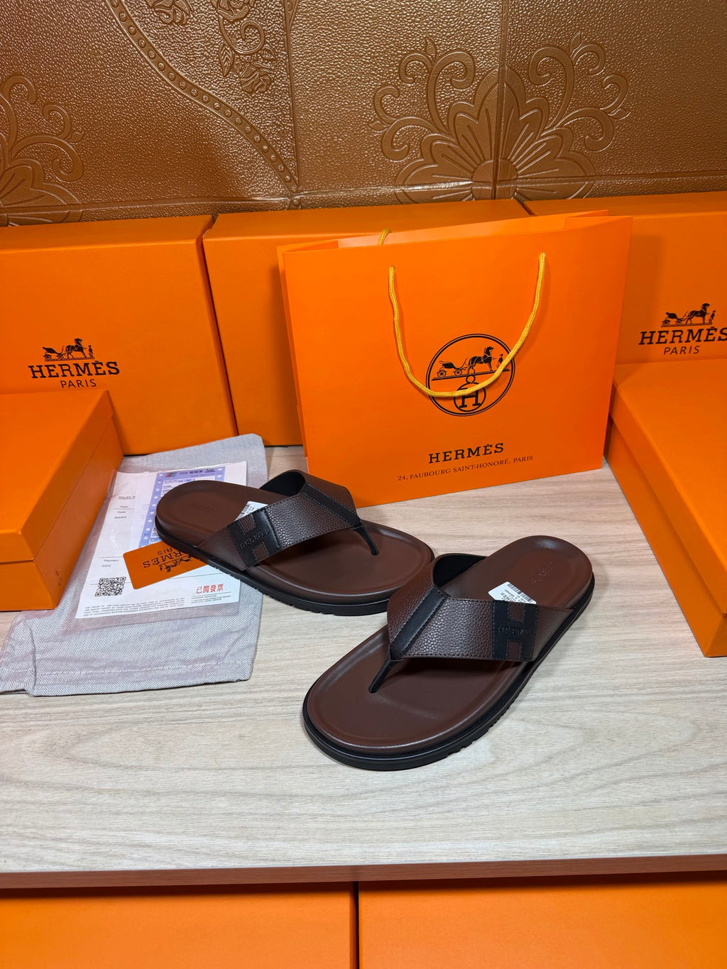 Dark leather slide sandals with black top strap and flat sole