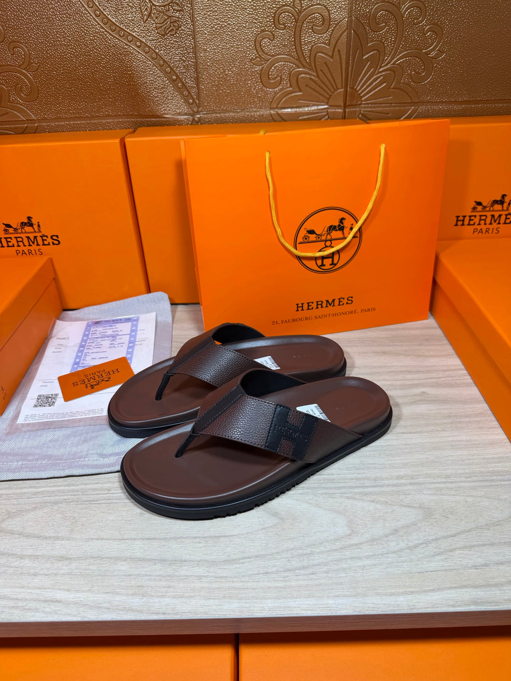 Dark leather thong sandals with wide V-front strap and flat sole