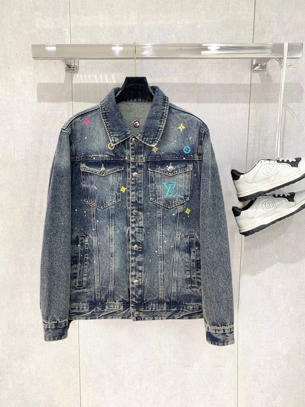 Denim jacket with button front, spread collar, and multicolor graphic patches