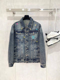 Denim jacket with button front, spread collar, and multicolor graphic patches