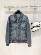 Denim jacket with button front, spread collar, and multicolor graphic patches