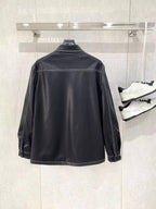 Black leather jacket by Prada with stand collar and long sleeves