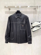 Leather jacket by Prada with stand collar, snap front, and chest pockets