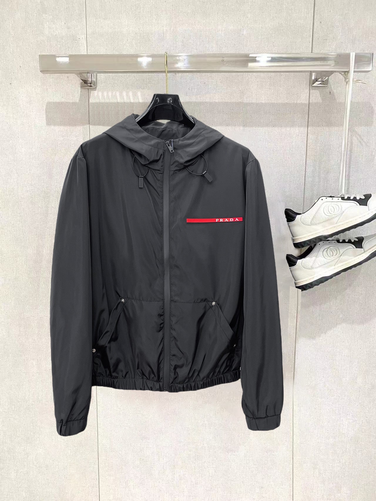 Prada long black hooded windbreaker jacket with front zipper and red logo stripe