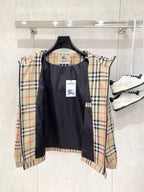 Reversible-style hooded jacket with black front and beige plaid sleeves