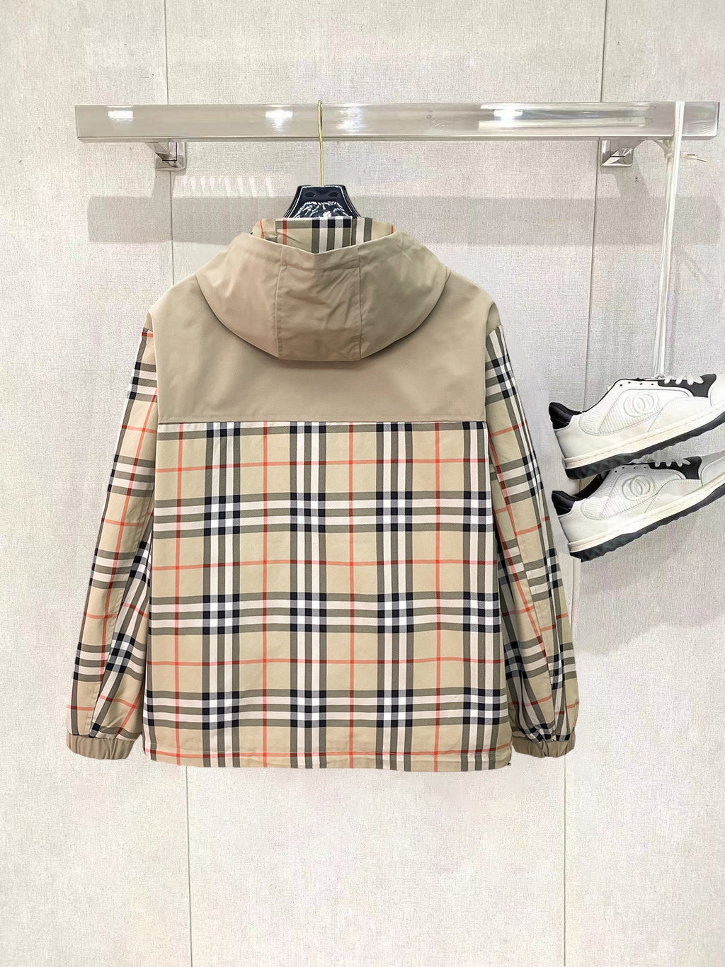 Hooded jacket back view with beige body, plaid sleeves, and full zip