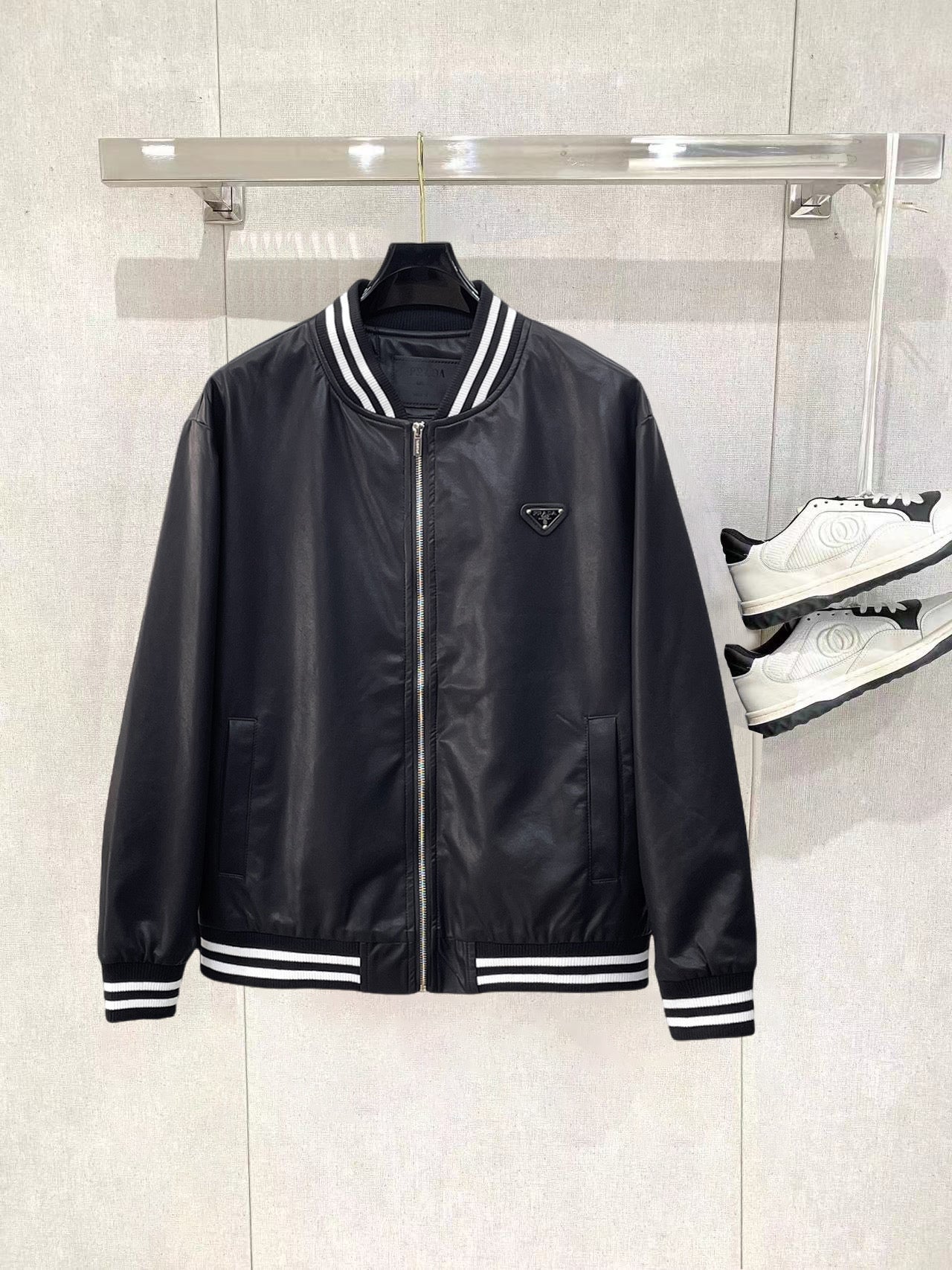 Black leather bomber jacket with striped ribbed collar and cuffs, zip front