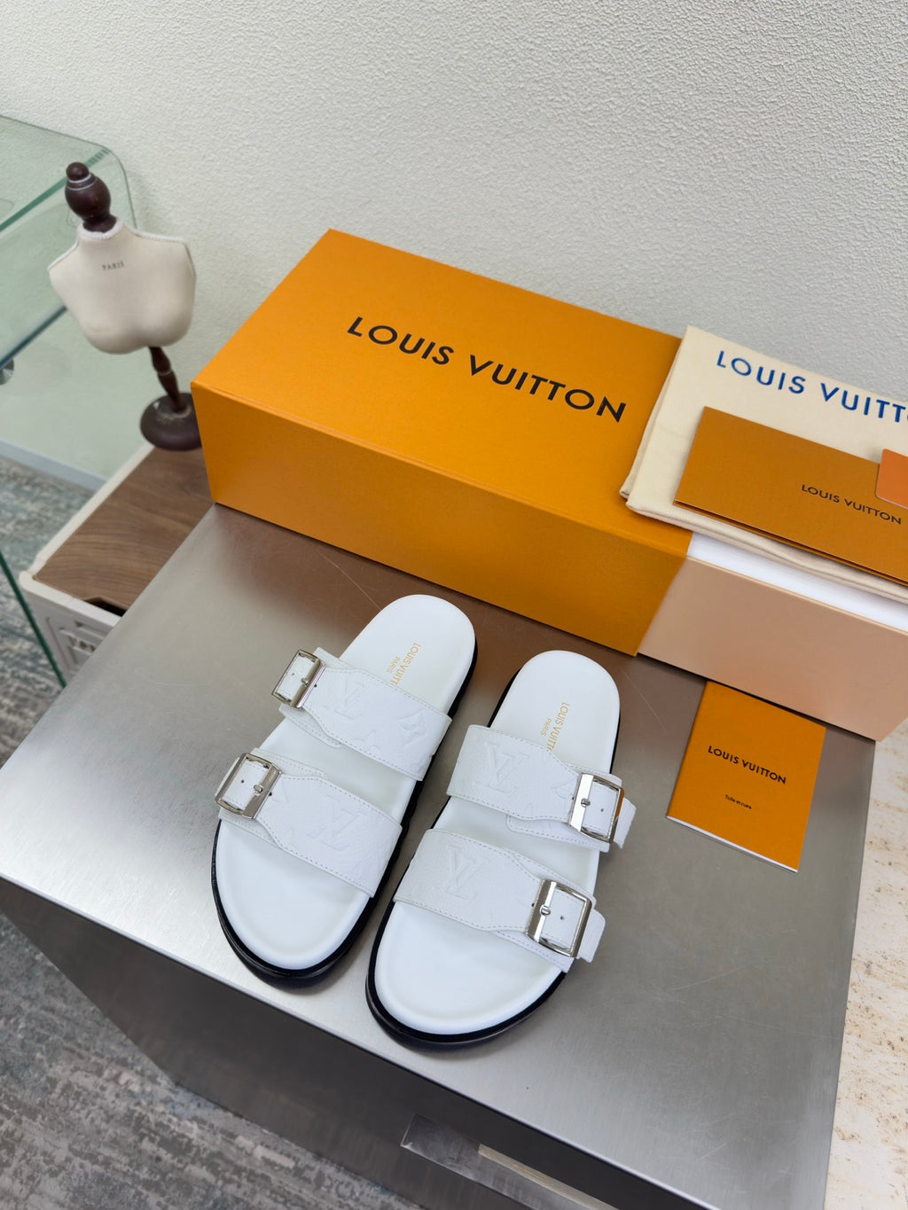 White Louis Vuitton sandals with two adjustable buckle straps and chunky sole