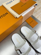 White Louis Vuitton buckle sandals, close-up on embossed straps and textured sole