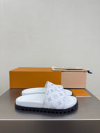 White monogram slide sandals with thick sole and strap detail