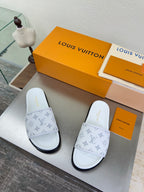 White monogram slide sandals with wide strap and dark sole