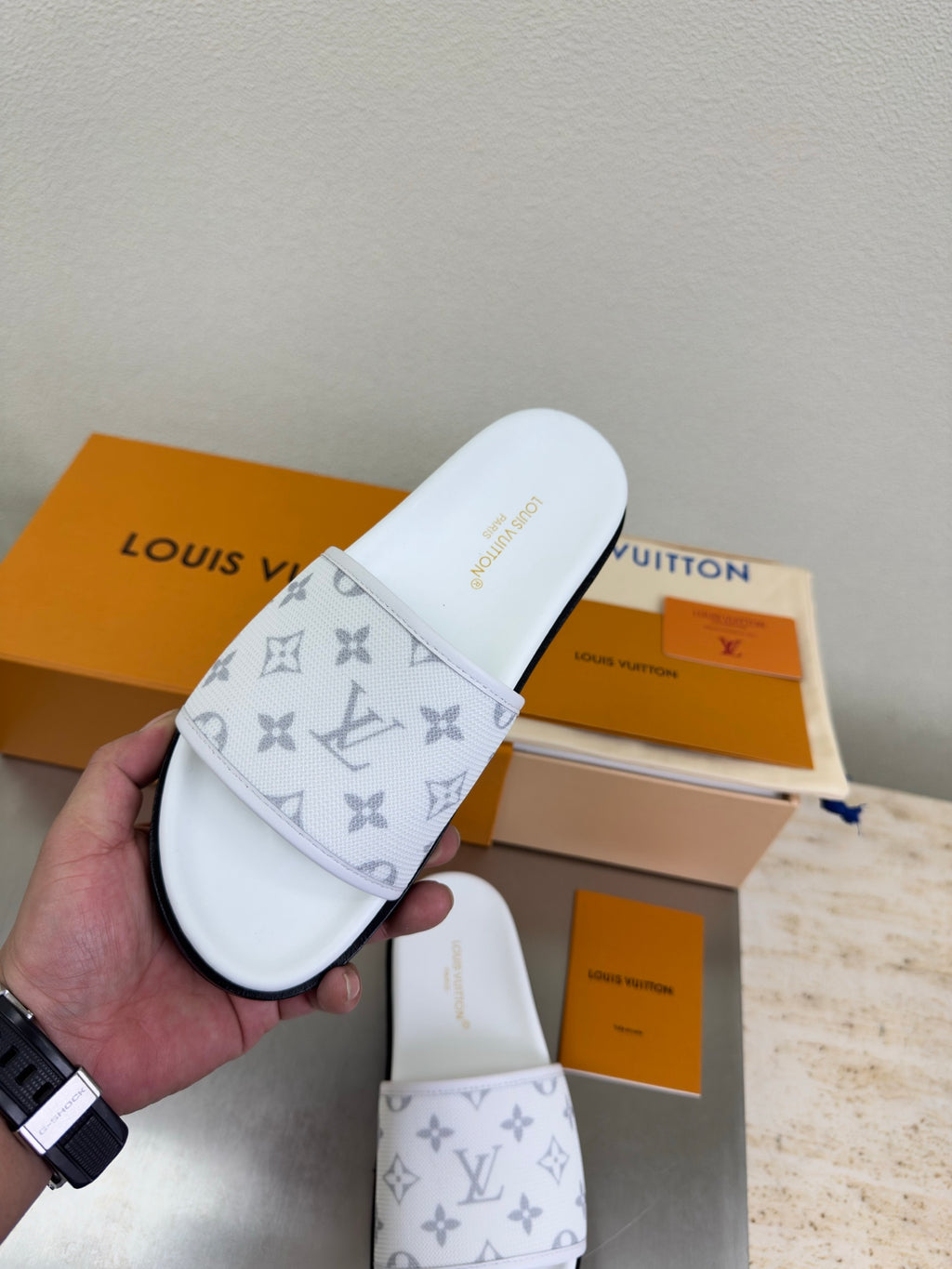 White slide sandal with monogram strap and open toe