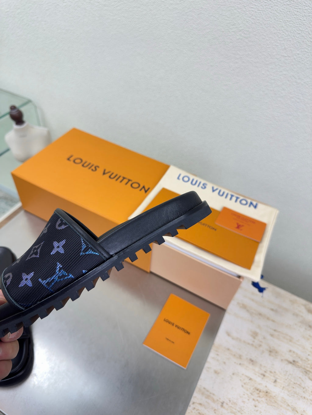 Louis Vuitton slide sandals with dark navy strap and blue monogram pattern
