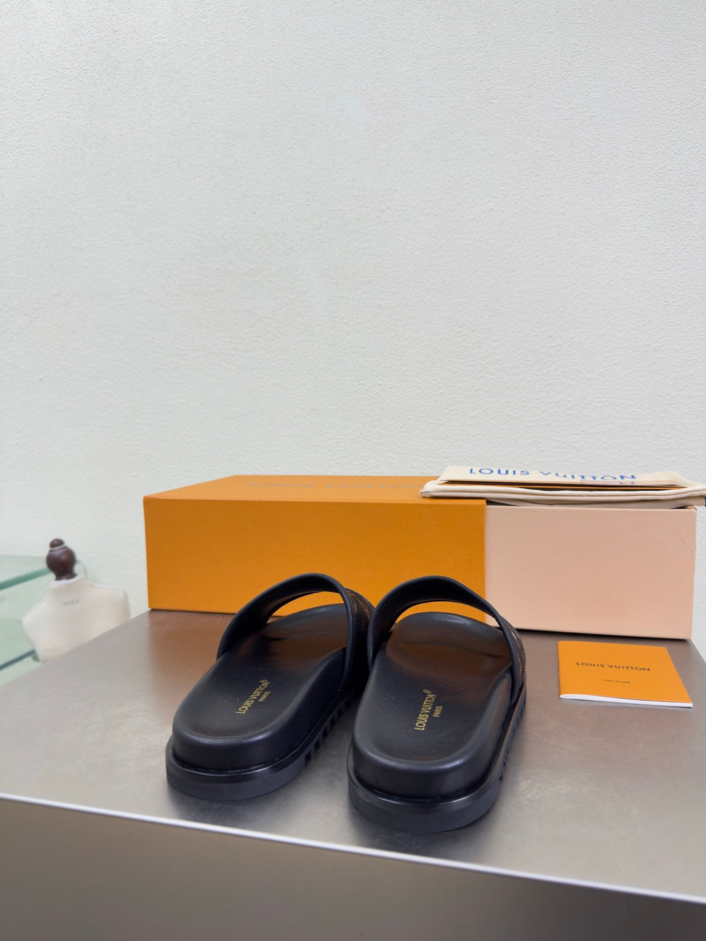 Louis Vuitton slide sandals with smooth dark upper and thin strap