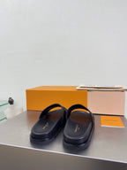 Louis Vuitton slide sandals with smooth dark upper and thin strap