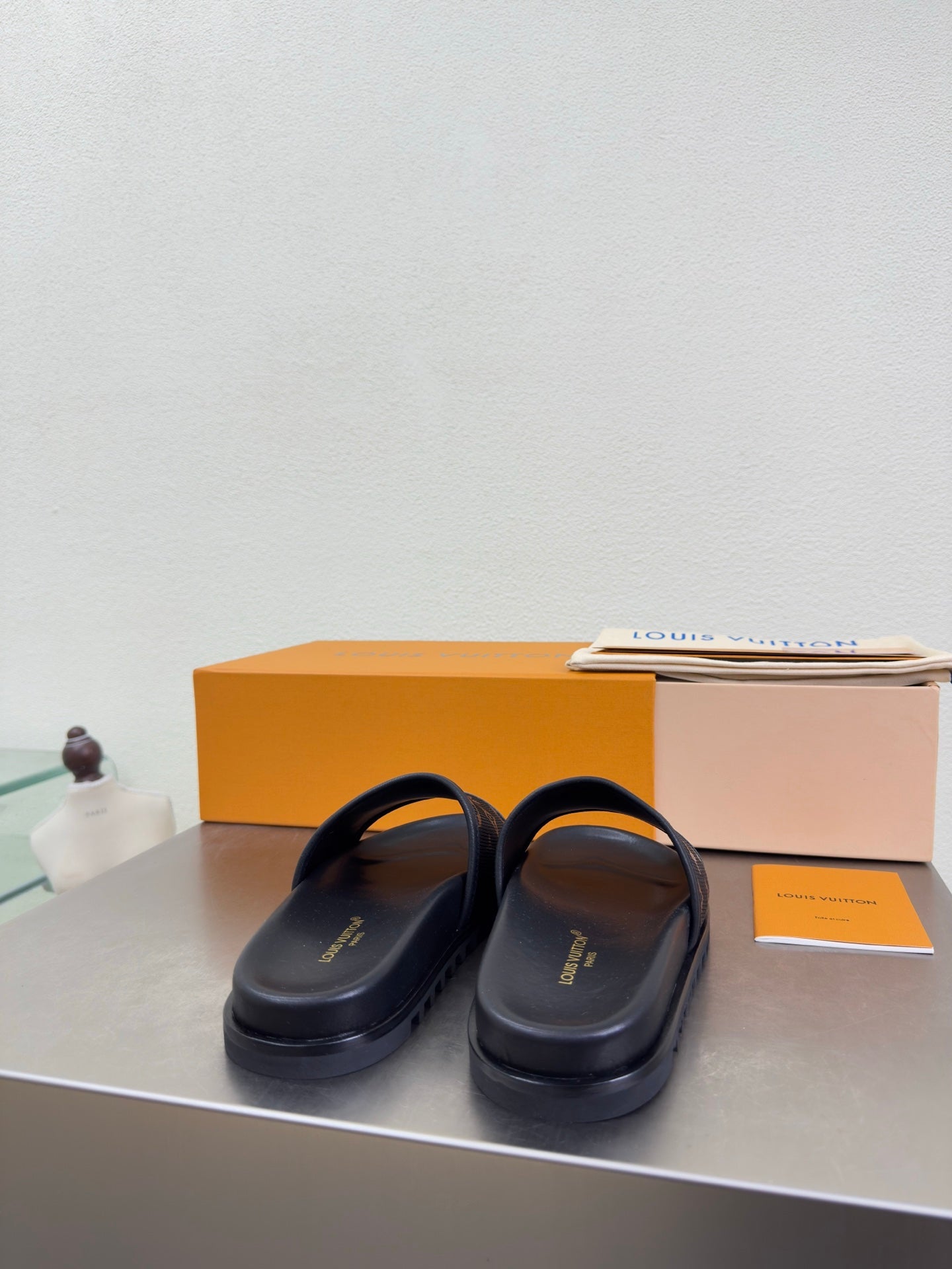 Louis Vuitton slide sandals with smooth dark upper and thin strap