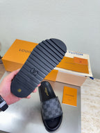 Louis Vuitton slide sandals showing textured tread sole and dark check-pattern upper