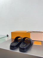 Louis Vuitton slide sandals with dark leather straps and check-pattern band