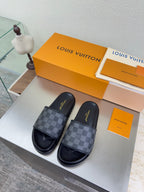 Louis Vuitton slide sandals with dark check-pattern straps and cushioned footbed