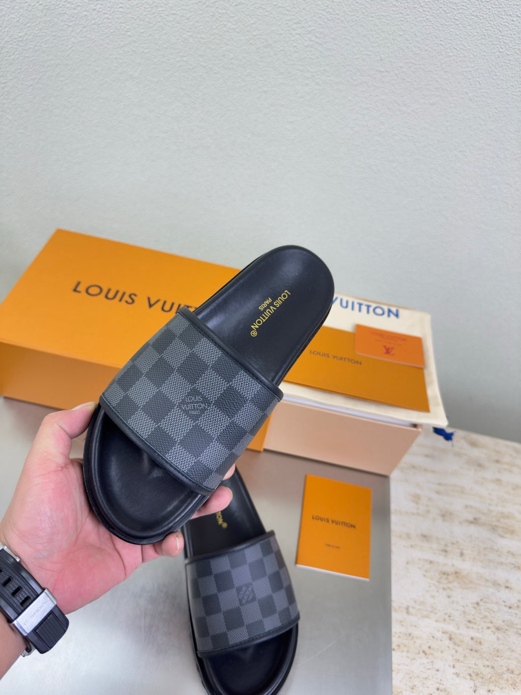 Louis Vuitton slide sandals, dark check-pattern band and black cushioned slide strap