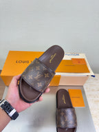 Louis Vuitton monogram slide sandal held up, dark brown footbed and strap