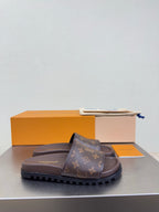 Louis Vuitton monogram slide sandal with dark brown footbed and tread sole