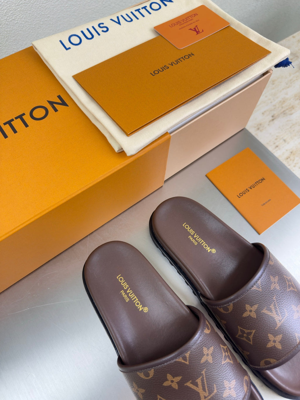 Louis Vuitton slide sandals with monogram upper and dark brown footbed