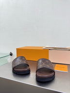 Louis Vuitton slide sandals with monogram straps and dark brown footbed