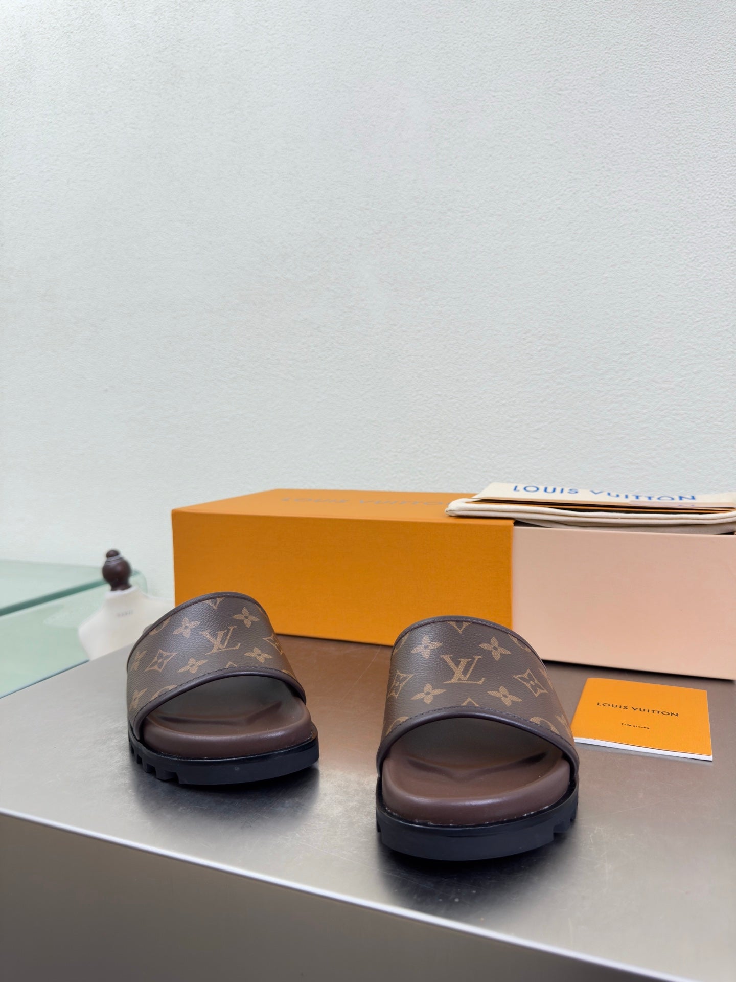 Louis Vuitton slide sandals with monogram straps and dark brown footbed