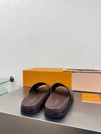 Louis Vuitton slide sandals with monogram straps and dark brown outsole