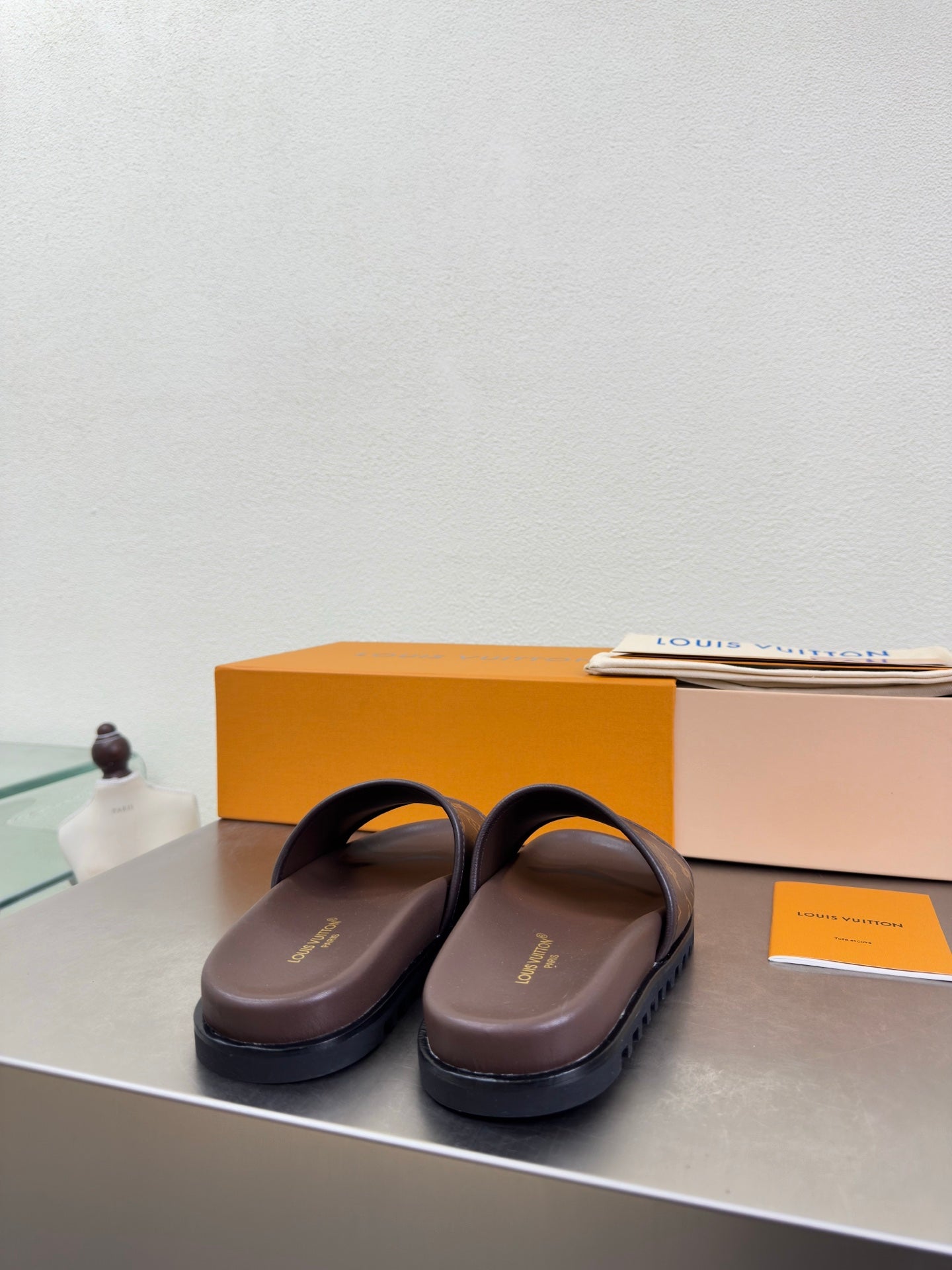 Louis Vuitton slide sandals with monogram straps and dark brown outsole