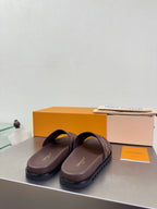 Louis Vuitton damier check slide sandals, brown slide style with cushioned top strap.