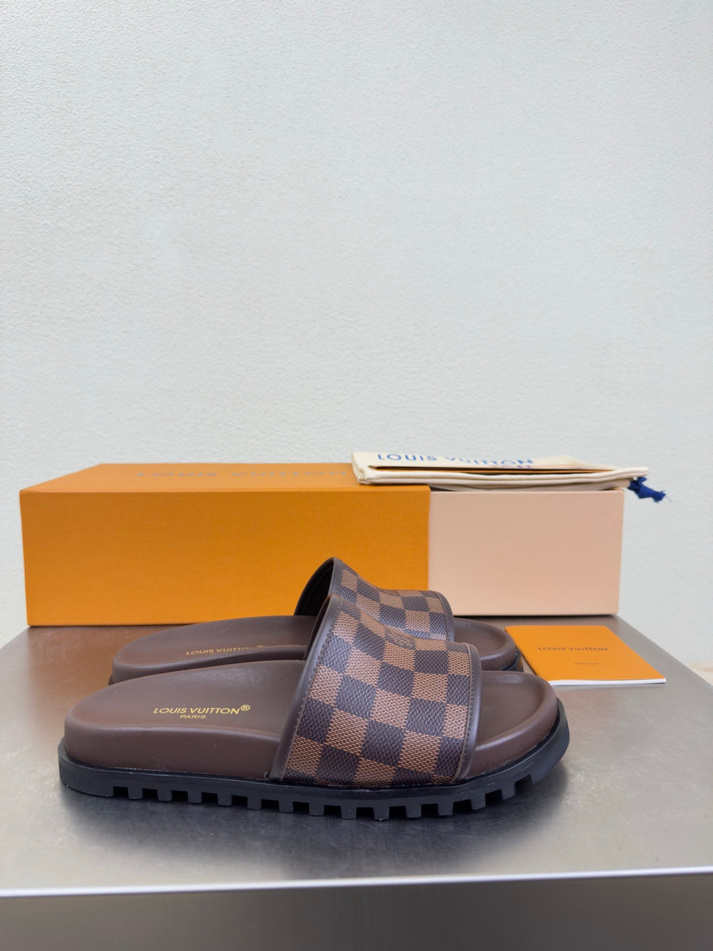 Louis Vuitton damier check slide sandals in brown, thick tread sole and padded footbed.