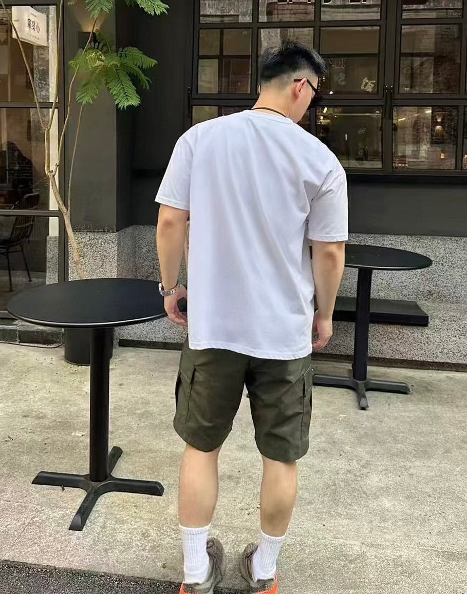 Olive cargo shorts with side seams and cuffed hem, 3/4 rear angle