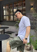 Olive cargo shorts with stitched cargo pocket and front button detail