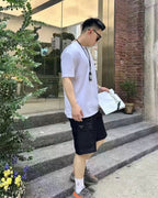 Prada black cargo shorts, above-knee length, side pocket detailing